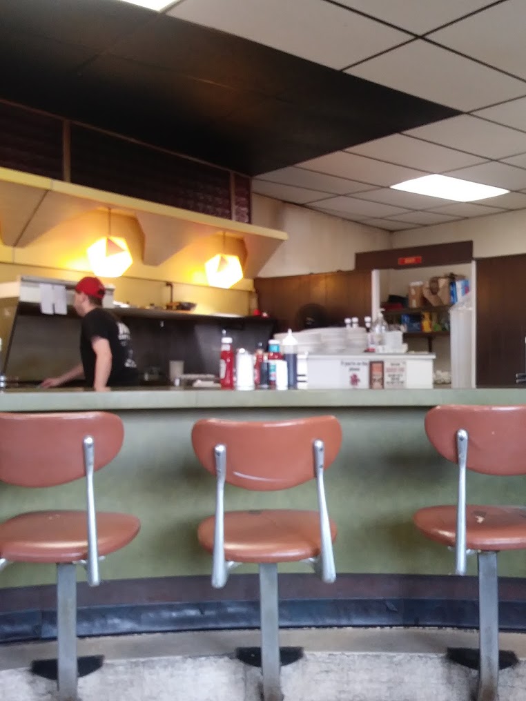 The curved counter and vintage stools inside The Why Coffee Shop