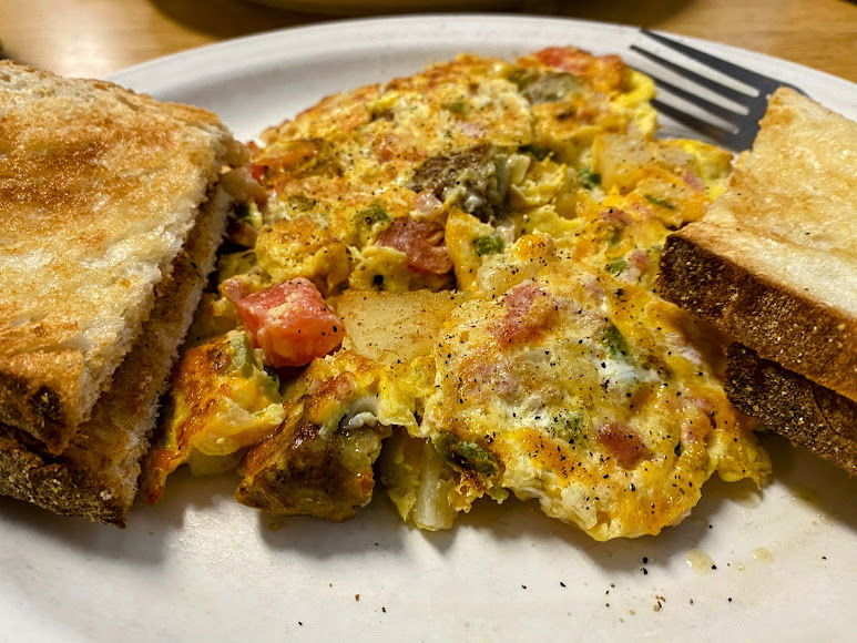 An omelet with thick toast served at The Why Coffee Shop